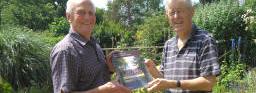 Norman Porter presents "History of Brandeston Hall" to David Mason